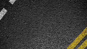 A close up of asphalt with some yellow dots