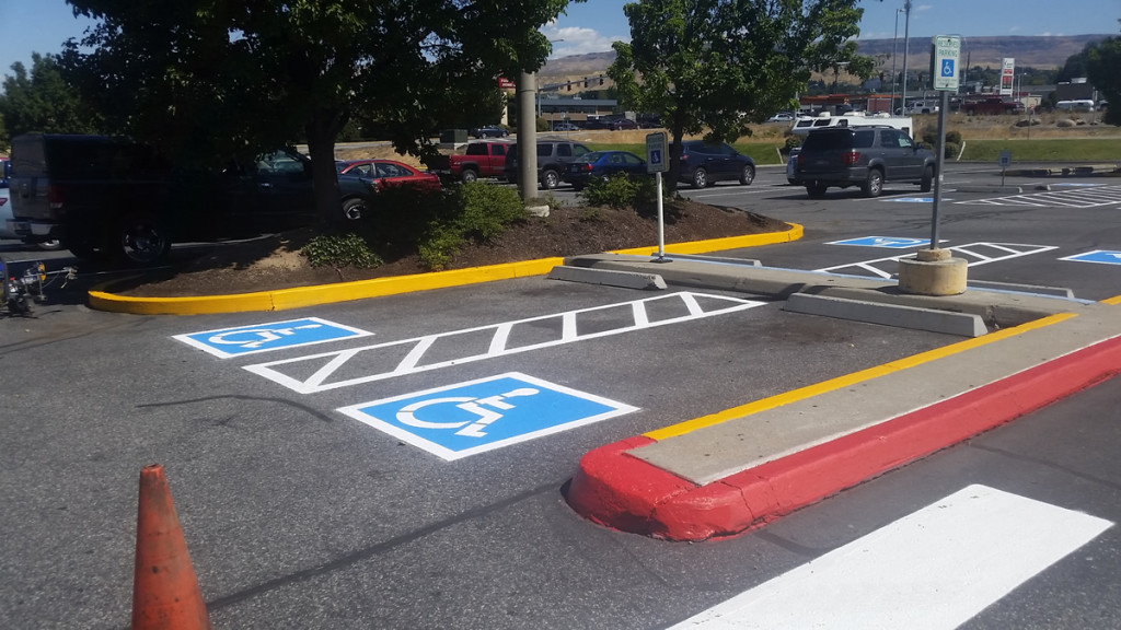 A parking lot with handicap signs painted on it.
