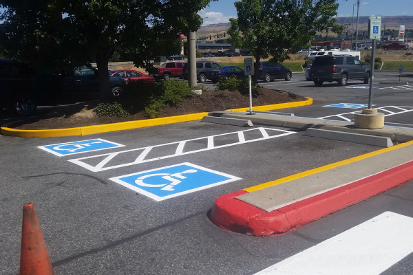 A parking lot with handicap signs painted on it.