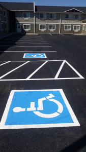 A parking lot with handicapped signs painted on it.