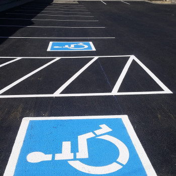 Parking with white lines and signs for people with disabilities