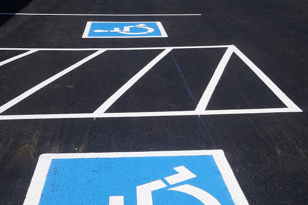 A parking lot with handicapped signs painted on it.