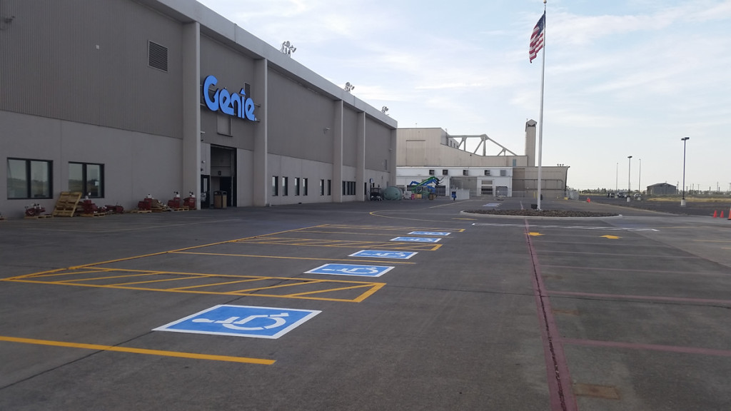 A parking lot with several blue and white numbered signs.