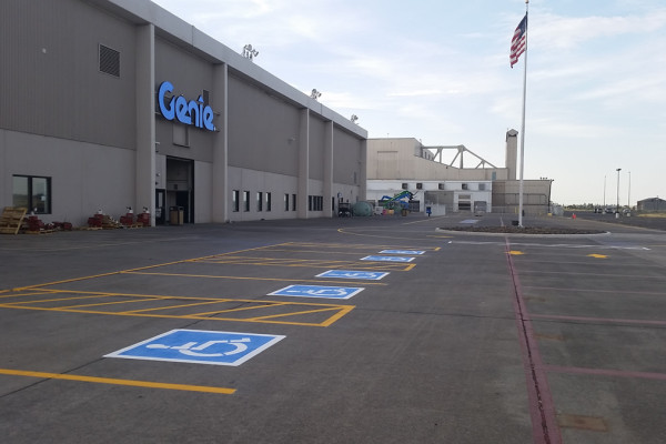 A parking lot with several blue and white numbered signs.