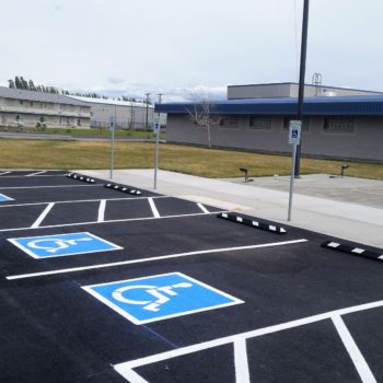 A Freshly Painted Parking Lot With Signs