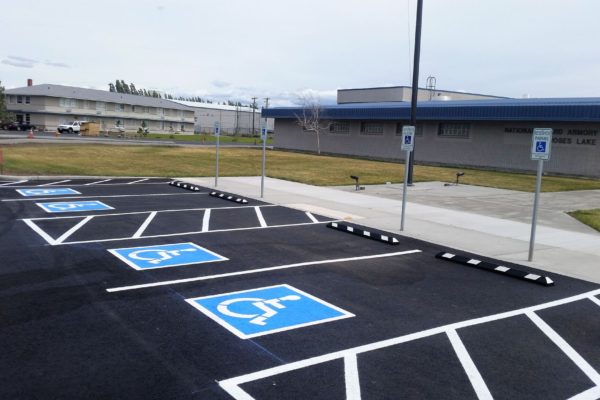 A parking lot with several handicapped signs painted on it.