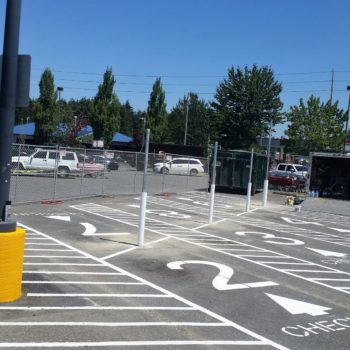 A parking lot with white markings and signs