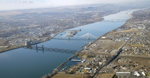 An aerial view of the Columbia River and the cable and blue bridges that span it and link the cities of Kennewick and Pasco in Washington state. Scientific models predict that rising temperatures will reduce the snowpack and glacier mass in nearby mountains, resulting in less water for the 1,243-mile-long Columbia River. That could mean less fish and damage to the riverÕs ability to churn out the hydro-power thatÕs worth billions of the dollars to the U.S. and Canada. (Tri-City Herald/MCT)