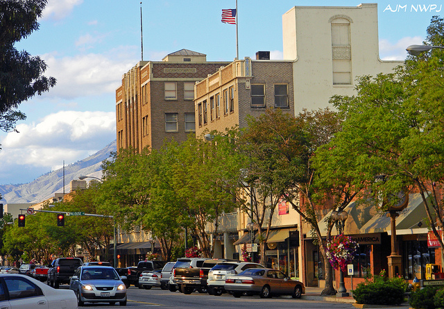 A street with many cars parked on the side of it