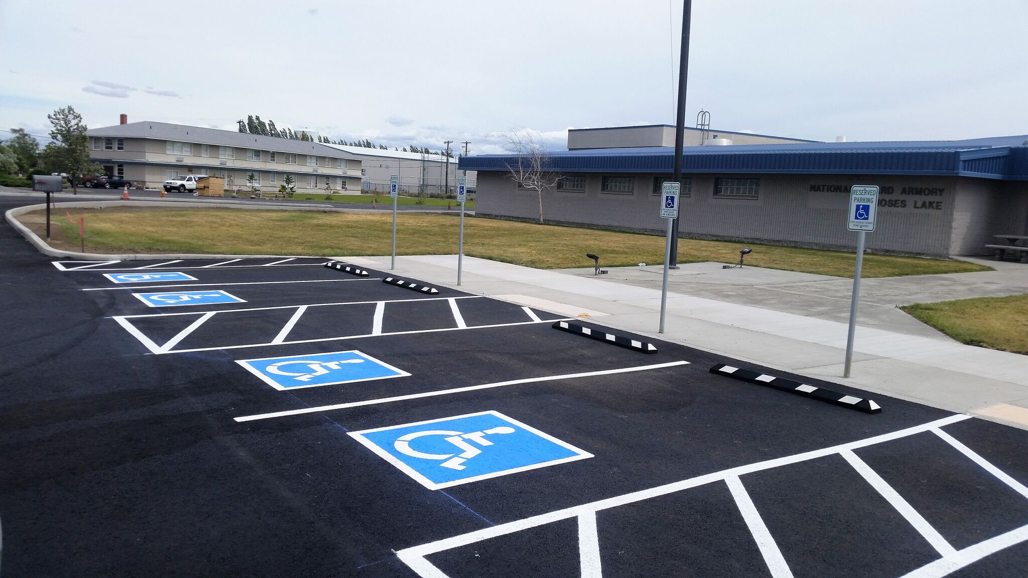A parking lot with several handicapped signs painted on it.