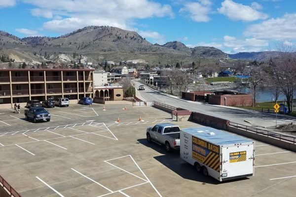 A van parked in an empty parking lot.