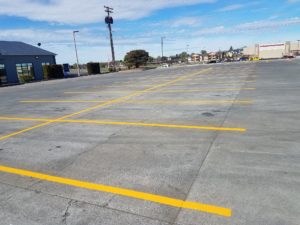 A parking lot with yellow lines painted on it.