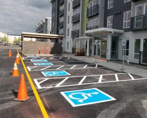 A parking lot with several different signs painted on it.