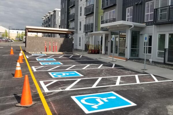 A parking lot with several different signs painted on it.