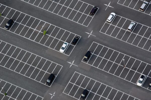 Aerial view of a parking lot with cars.